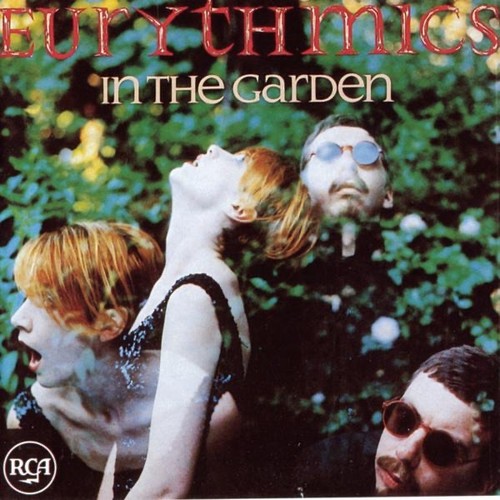 Eurythmics – In the Garden cover art: red Eurythmics lettering and cream In The Garden title over a layered photo of Annie Lennox and Dave Stewart against green garden foliage