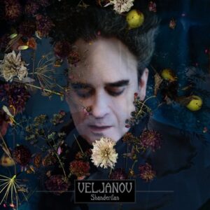 Veljanov – Shanderilan album cover: Alexander Veljanov's face with eyes lowered, seen through a dark blue haze of dried flowers, berries and small yellow pears, with the VELJANOV logo and Shanderilan in a framed black box at the bottom