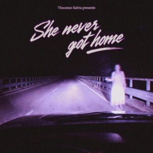 Vincenzo Salvia – She never got home single cover: a night view through a car windscreen of a lonely bridge road, with a pale ghostly woman in white standing by the guardrail and the title in pink script above