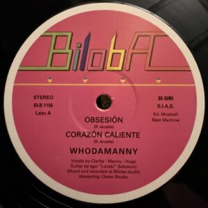 Whodamanny – Obsesión / Corazón Caliente: pink Biloba vinyl label with the rainbow-outlined Biloba logo, catalogue number BLB 1156, the two song titles and the name Whodamanny in white
