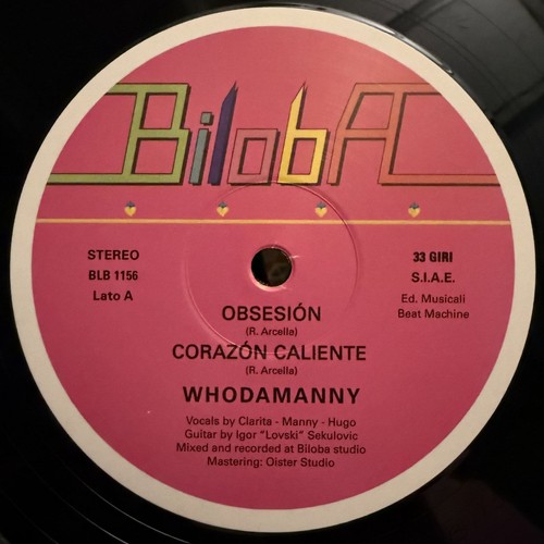 Whodamanny – Obsesión / Corazón Caliente: pink Biloba vinyl label with the rainbow-outlined Biloba logo, catalogue number BLB 1156, the two song titles and the name Whodamanny in white
